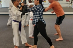 Parents work on punching during a cardio drill while their KFMA kids hold the targets!