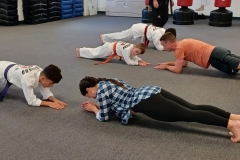 Parents and kids enjoying the 'plank' which allows them to work their abs! The plank is one of the best all-around abdominal exercises! 