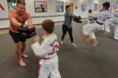 During 'Bring Your Parent to Class Day,' the parents are holding targets while their KFMA Kids work on kicks! 