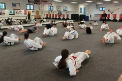 Working the abs during the warm-up is typical, as the core muscles play an important role in martial arts training. 