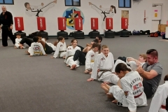 KFMA Kids hold their parents' legs while they work on sit-ups! All of the parents worked hard in the Family Class! 