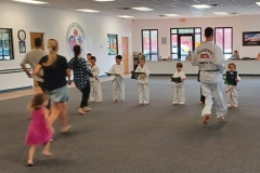 KFMA Tigers holding the targets while their parents work during a cardio drill!