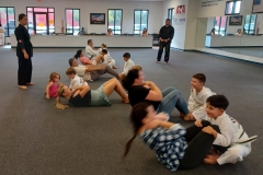 Parents enjoying sit-ups while their kids are holding! 