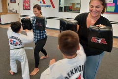 Parents having fun holding targets while the Tigers work on cross-punching!