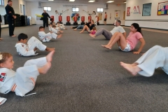 Tigers and their parents work their lower abs between rounds of kicking and punching on targets! 