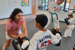 While their Tiger kids hold the targets, the parents work on kicking and punching drills!