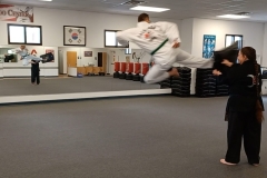Airborne! Adults practicing running jump side kicks during a Family class! 