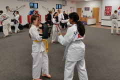 Teen girls working together during a KFMA Family class!
