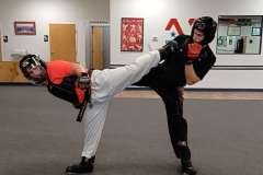 The reverse side kick is a quick counter in sparring, as demonstrated by two Adult Black Belts. 