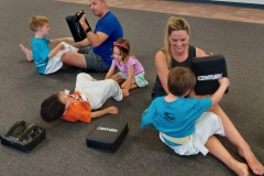 Mom and Dad working with their kids during a sit-up drill in Tiger class. Little sister joins in to help! Mom and Dad working with their kids during a sit-up drill in Tiger class. Little sister joins in to help!