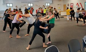 Women practicing knee strikes at KFMA Women's Self defense seminar