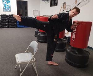 KFMA Creates Positive Habits for Fitness and Strength as shown by this KFMA Black Belt practicing 'perfect' side kicks with repetition.