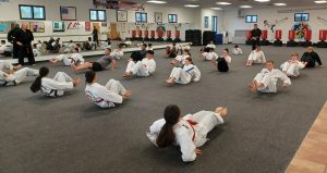 Working the abs during the warm-up is typical, as the core muscles play an important role in martial arts training.