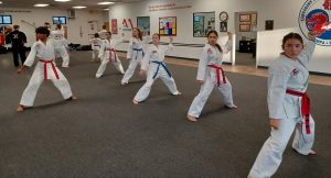 During a KFMA Family Martial Arts class, students are broken into traditional Taekwondo rank groups to work on their Songahm Taekwondo Forms. Many also practice at home using KFMA Training Videos.