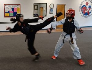 Teen black belt girls can develop incredible speed and flexibility, and must use self-control during their sparring matches.
